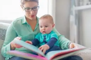Image of a woman providing child care for a baby at her home-based business
