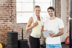 Image of a woman working with her personal trainer at his home-based business