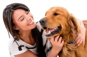 Image of a woman taking care of a dog as a pet sitter for her home-based business