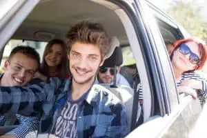 Image of a rideshare driver with a car full of people