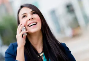Businesswoman talking on the phone and experiencing the benefits of call forwarding