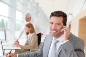 Businessman using call forwarding in an office