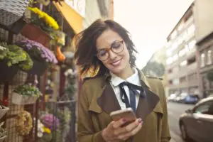 woman using her phone to browse the sales leads collected by Map Communications