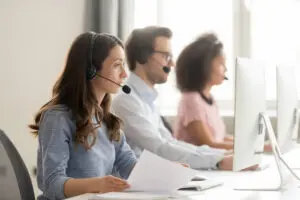 Three call center agents answering phone calls