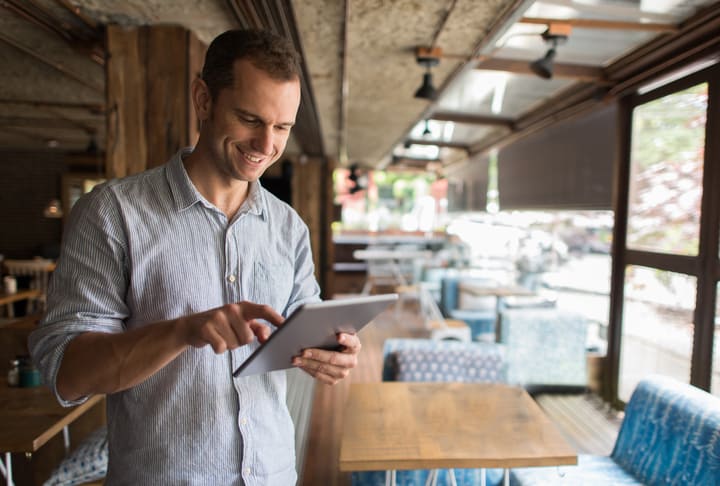 Image of a man with tablet managing his direct response call center program
