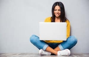 Image of a woman blogging for her home-based business