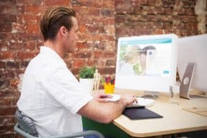 Image of a man performing website management tasks for his home-based business
