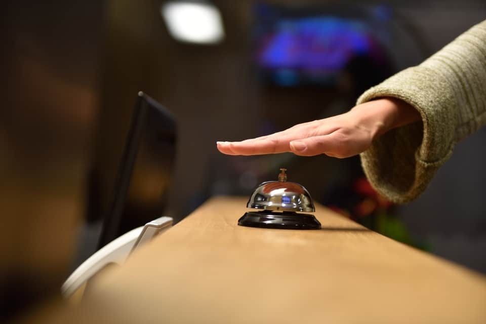 Image of a person checking in at establishment that uses a hotel answering service