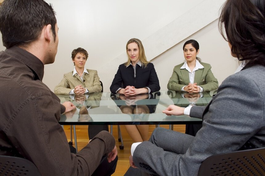Image of a room with family members and family law attorneys making a negotiation while an answering service for family lawyers covers the phones