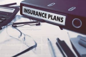 Image of a binder containing insurance plans in the office of an insurance company