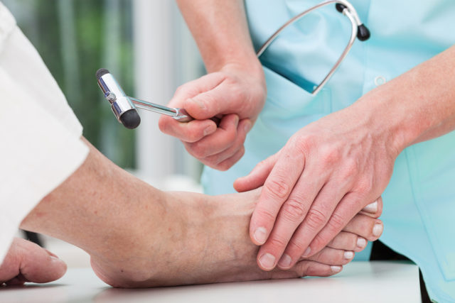 Image of a podiatrist treating a patient's foot