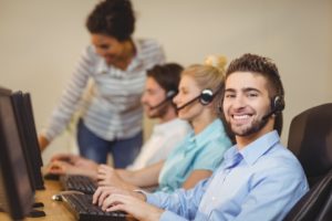 Four employees working in a call center for real estate investors