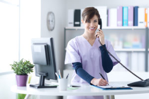 Medical Receptionist at Her Desk