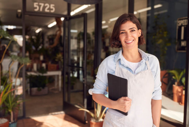 Woman Business Owner In Front Of Her Business