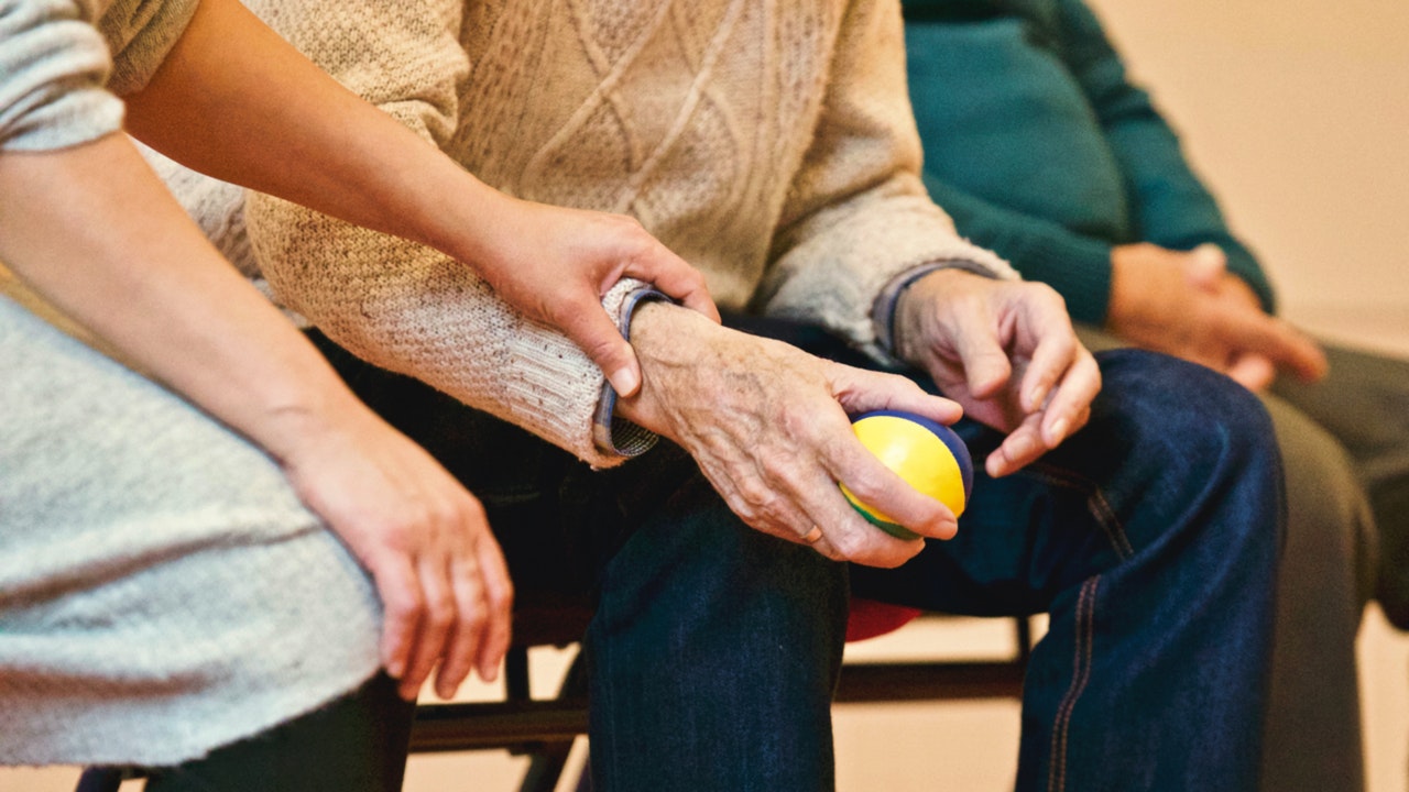 image of a staff member helping a resident at a nursing home