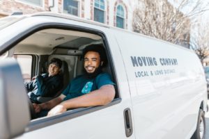 two men in a moving van that use a virtual receptionist for their business calls