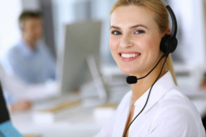 woman with a headset working for a call center outsourcing company