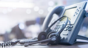 image of a telephone and headset on a desk