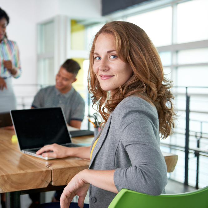 Image of five people in a conference room who are using an answering service for small businesses