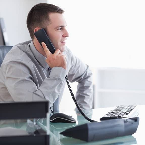 Image of a businessman receiving a transferred call from his virtual receptionist