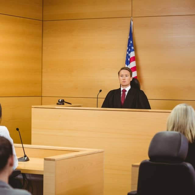 Image of a courtroom with lawyers that use a legal answering service