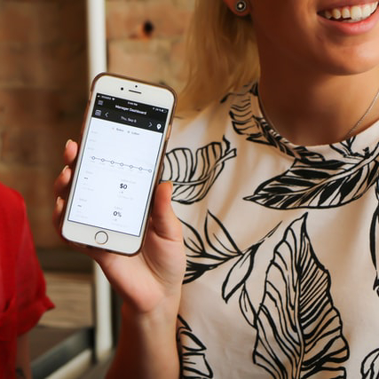 Image of two women and their phones using a live answering service for small business