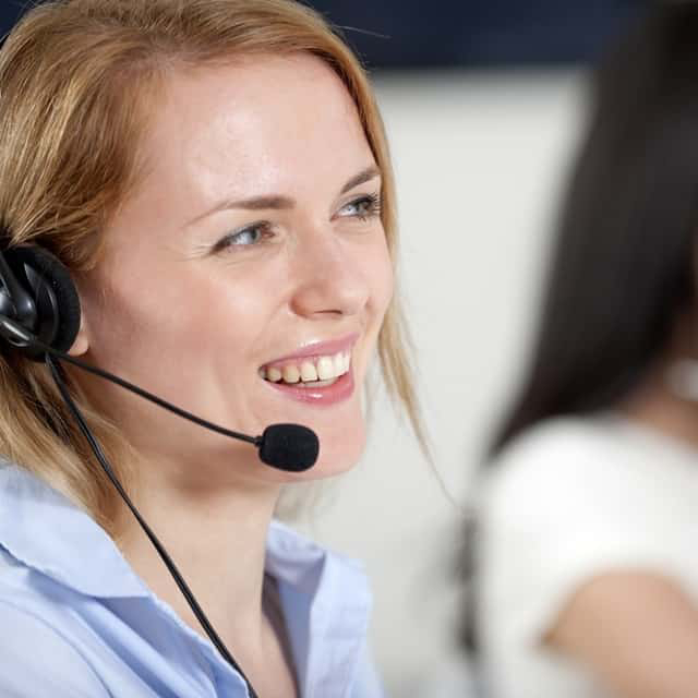Image of two receptionists providing call center service for a restoration company