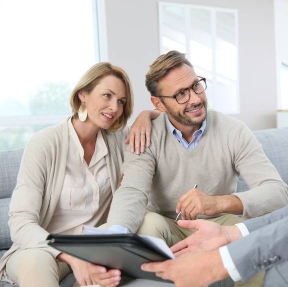 financial advisor meeting with a couple of clients