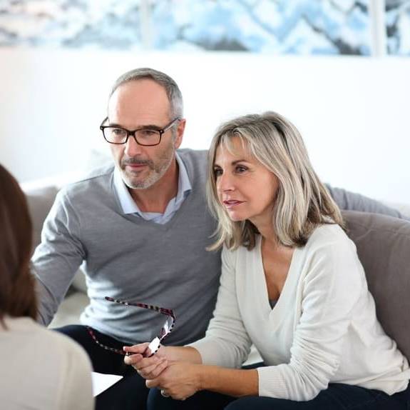 Image of a couple speaking with an attorney that uses an estate, trust, and elder law answering service