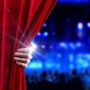 Image of a stage curtain being pulled back at a theater that uses a call center for the entertainment industry