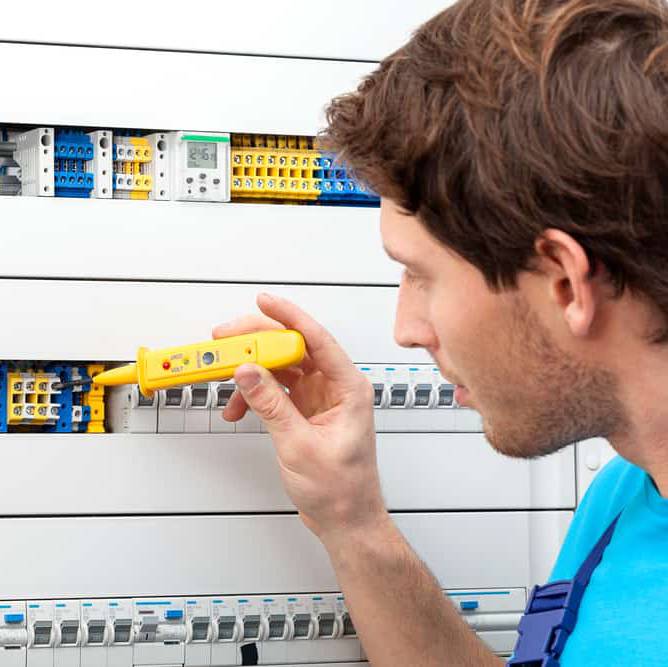 Image of an electrician checking voltage