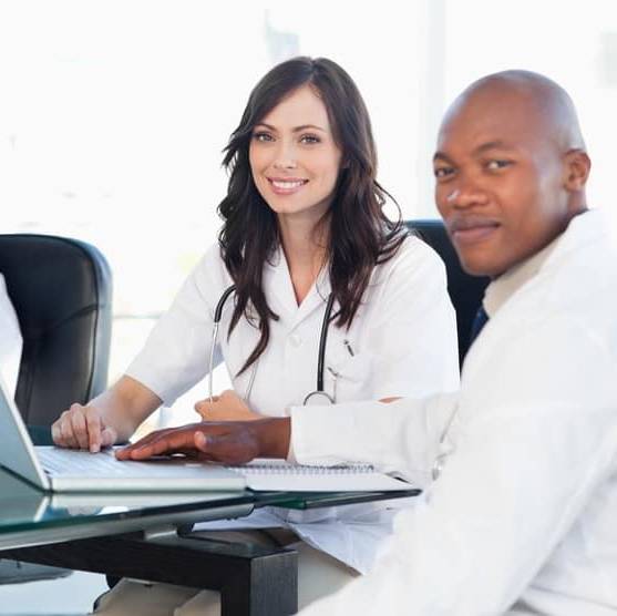 Image of four members of a medical team that use Map Communications answering service for hospitals