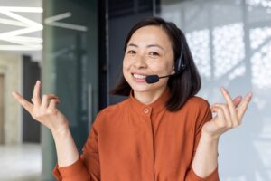 virtual receptionist looking at camera and shrugging shoulders with hands up